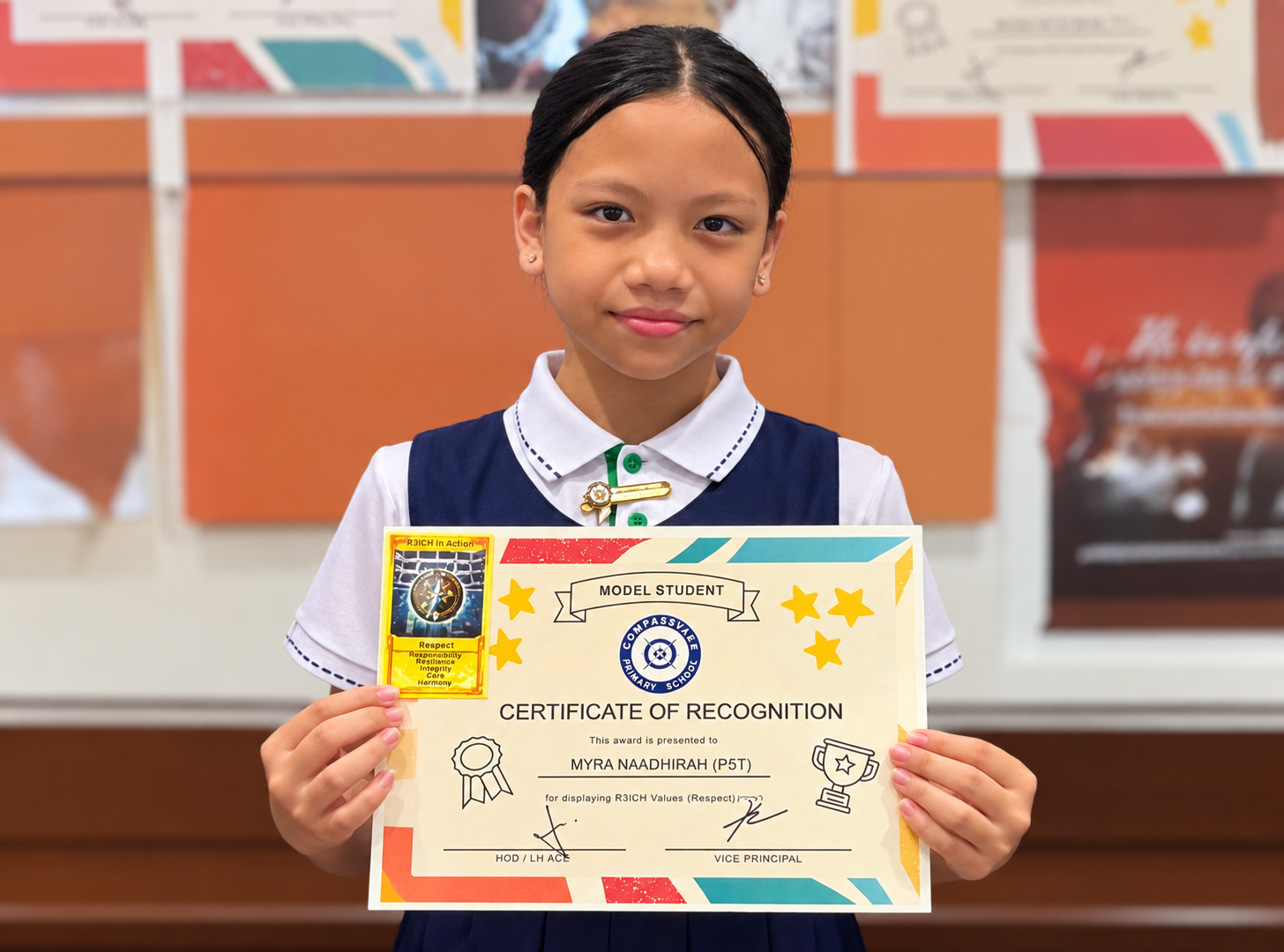 Student holding a Model Student certificate and award card recognising her demonstration of R3ICH value Respect.